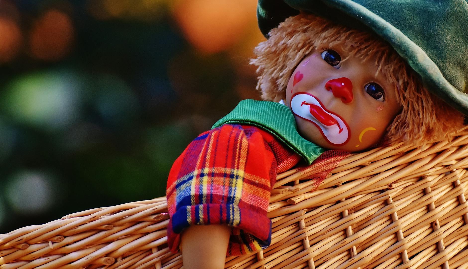 sad clown doll in basket