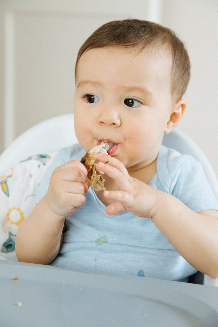 a close up shot of an infant eating food